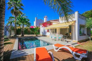 a villa with a swimming pool and a house at Villa Monet ONLY FAMILIES in Cambrils