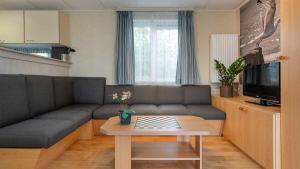 a living room with a couch and a table at Molecaten Park Wijde Blick in Renesse
