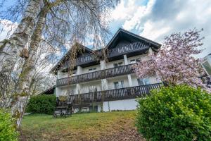 a large white building with a balcony at Bierenbacher Hof in Nümbrecht +52 photos