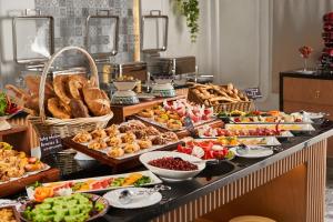 a buffet with different types of food on a table at Mövenpick Samarkand in Samarkand