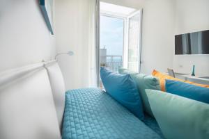 a room with blue and orange pillows and a window at DOMUS LINA in Sorrento