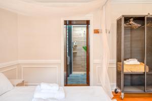 a bedroom with a bed and a walk in shower at Madeira Loft II - FREE CAR in Caniço