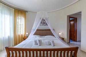 a bedroom with a large bed with white sheets and pillows at Altea Buena Vista in Altea