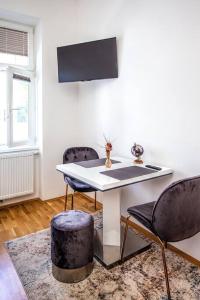 a dining room with a table and two chairs at Cozy apartment Studio in Vienna