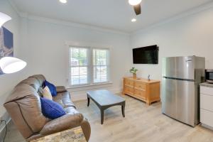 a living room with a couch and a refrigerator at Coastal North Carolina Retreat - Walk to Beach! in Oak Island
