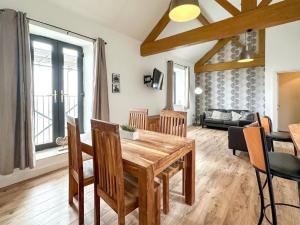 a living room with a wooden table and a couch at Coronation Mill Apartment in Mow Cop