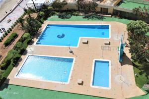 an overhead view of two large swimming pools at 29D Vistas espectaculares parking and wifi in Calpe