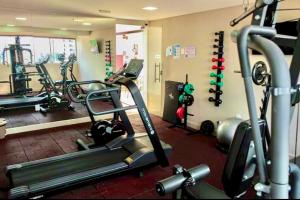 a gym with several tread machines in a room at PHGFlats Manaira apart hotel in João Pessoa