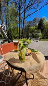 a table with a drink on top of it at Pod Platanem Gliwice in Gliwice