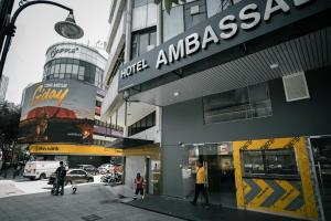 a store with a sign on the side of a building at Hotel Ambassador @ Bukit Bintang in Kuala Lumpur