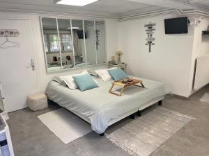 a bedroom with a bed with a table on it at Sur la route des peintres in Champagne-sur-Oise