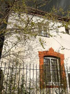 a fence in front of a building with a window at Casa Josephine Riofrío - retiro a 1 h de Madrid in La Losa
