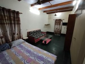 a living room with a bed and a couch at HERITAGE HOMESTAY@OLD CITY NEAR GANGES in Varanasi