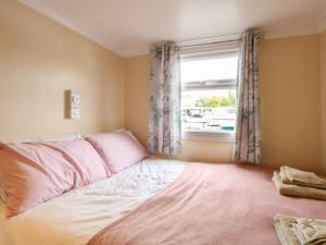 a bedroom with a bed and a window at Ardea in Norwich