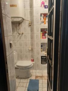 a small bathroom with a toilet in a room at Apartment ЖУЖУНА in Batumi
