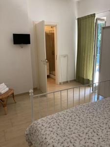 a bedroom with a bed and a door to a hallway at A Suata in Maratea