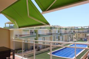 a balcony of a building with a swimming pool at Delfines III Solo Familias Serviplaya in Playa de Xeraco