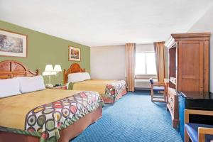 a hotel room with two beds and a desk at Super 8 by Wyndham West Memphis in West Memphis
