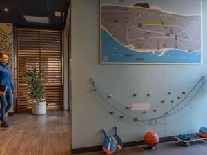 a room with a wall with a picture of a ship at Ibis Budget Barcelona Viladecans in Viladecáns