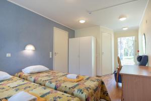 a hotel room with two beds and a desk at Villa Andropoff in Pärnu +44 photos
