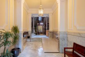 a hallway with a staircase in a building at Barcelonaforrent The Gaudí Suites in Barcelona