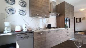 a kitchen with wooden cabinets and plates on the wall at Il Mulino di Marena in San Siro +29 photos