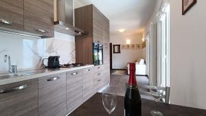 a kitchen with a bottle of wine on a table at Il Mulino di Marena in San Siro