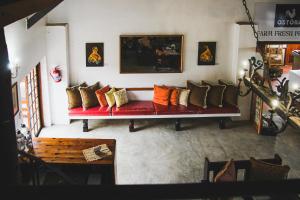 a living room with a red couch with many pillows at The Residence at Villa Wiese in Swakopmund