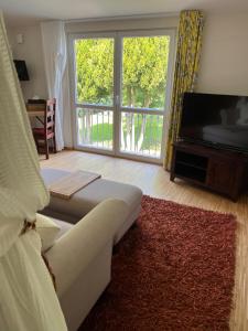 a living room with a couch and a large window at GästeHaus Auler Hof in Kröv