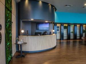 a lobby of a hotel with a reception desk at Novotel Puerto Montt in Puerto Montt