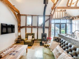 a living room with a couch and a table at The Victorian Stables in Kimpton