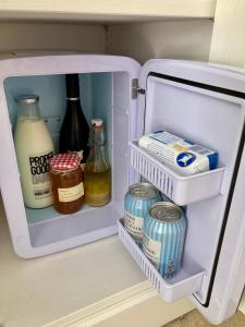 an open refrigerator with food and drinks in it at The Costrel in Tenbury