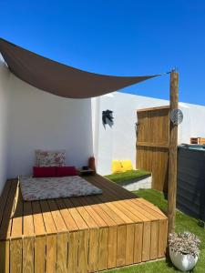 a bedroom with a bed on a wooden deck at Moradia Bispo in Aljubarrota