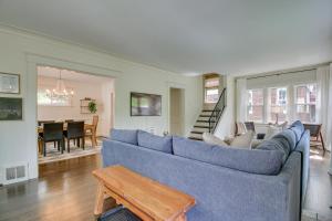 a living room with a blue couch and a table at Pet-Friendly Cincinnati Retreat with Hot Tub in Blue Ash