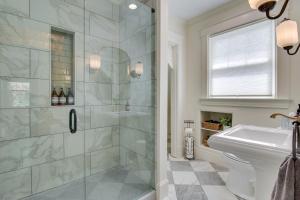 a bathroom with a shower and a toilet and a sink at Pet-Friendly Cincinnati Retreat with Hot Tub in Blue Ash +21 photos