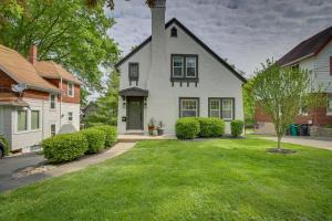 a white house with a grass yard in front of it at Pet-Friendly Cincinnati Retreat with Hot Tub in Blue Ash
