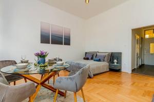 a living room with a table and a couch at BluebellHome-Castle District in Budapest