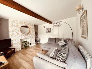 a living room with a couch and a fireplace at Cosy cottage four miles from Lincoln city centre in Lincoln
