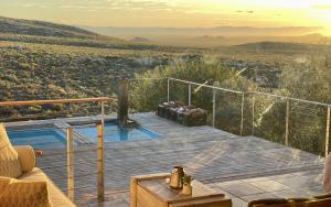 une maison avec une terrasse et une piscine dans l'établissement Tierkloof Mountain Cottages, à Breede River DC