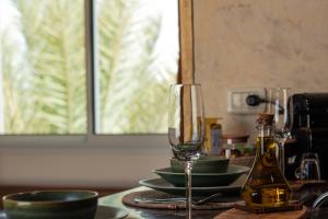 a table with two wine glasses and plates on it at Cozy Studio with Rooftop Terrace & Cityscape Views in Le Bardo +20 photos