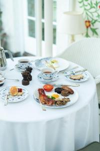 a table with plates of food and cups of coffee at Ballymaloe House Hotel in Ballycotton