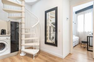 a white staircase in a room with a washing machine at Inviting duplex in front of Picasso Museum by REMS in Málaga