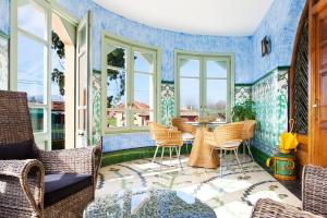a room with a table and chairs and windows at La Casona del Viajante - Adults Only in Villabajo