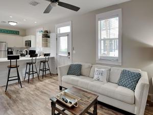 a living room with a couch and a table at Bungalows At Seagrove 149 - Three Little Birds Bungalow in Seagrove Beach