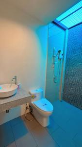 a bathroom with a shower and a toilet and a sink at Bests Village & Villa - Chalong Bay Phuket in Chalong