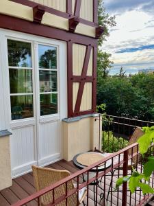 a house with a balcony with a door and chairs at Haus Hedwig in Heringsdorf