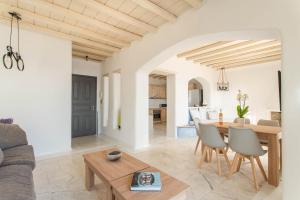 a living room and dining room with a table and chairs at Villa Alitis by Mykonos Rocks in Mikonos