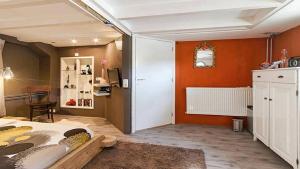 een slaapkamer met oranje muren en een bed in een kamer bij Studio in Woonboot + privébadkamer en -tuinterras in Utrecht