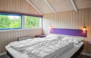 a bedroom with a large bed and two windows at 3 Bedroom Nice Home In Hemmet in Hemmet