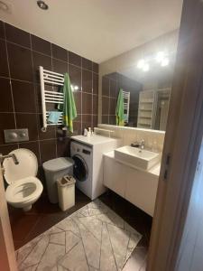 a bathroom with a toilet a sink and a mirror at Açık havuz ve deniz manzarası sunan site ev in Istanbul